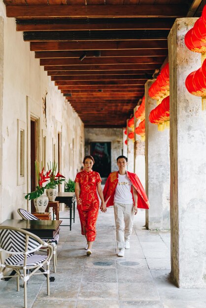 Happy young Asian couple love in Chinese traditional dresses - Red is the main color of the traditional festive that including wedding in China.