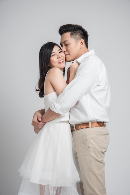 Happy young Asian couple in love embracing