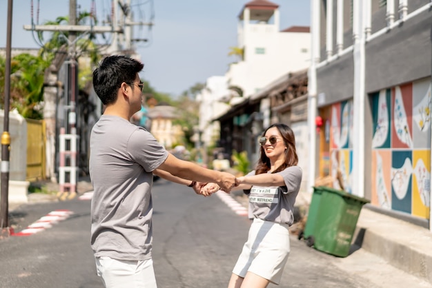 Happy young Asian couple in love having a good time