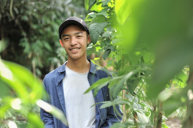 Happy of young Asian farmer male smiling at the camera, on the garden location.