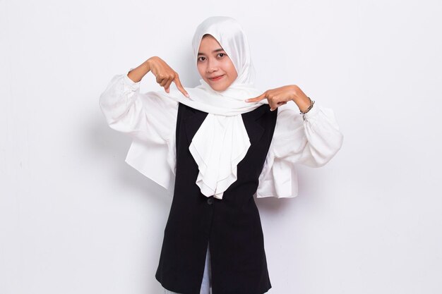 Happy young asian muslim business woman pointing with fingers to different directions  on white