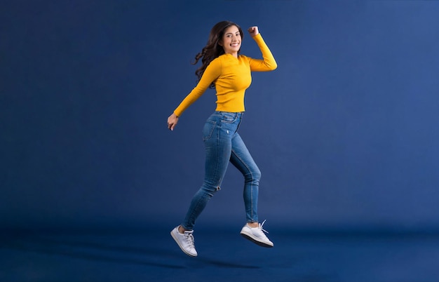 Happy young Asian woman in colorful yellow color casual clothes jumping