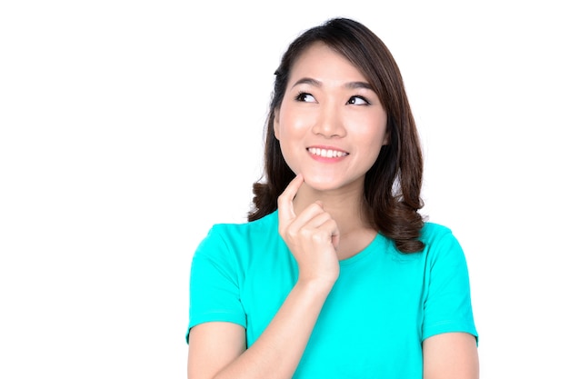 Happy young Asian woman thinking and looking up