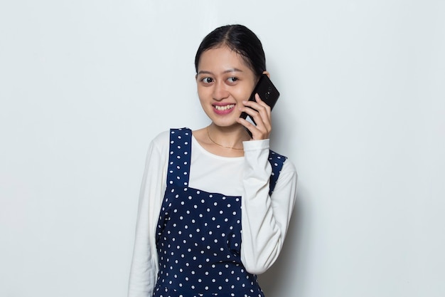 Happy young asian woman using mobile phone