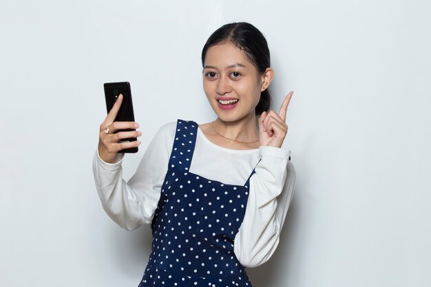 Happy young asian woman using mobile phone