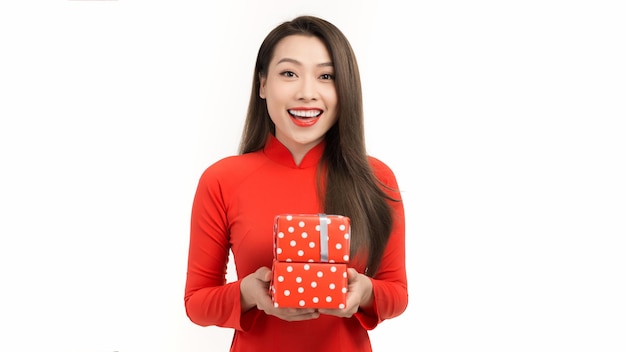 Happy young asian woman in vietnamese traditional costumes with presents