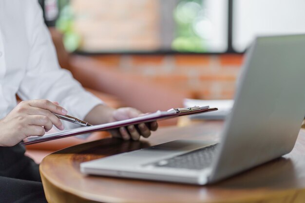 Happy young Asian Woman working on computer Business Data Analyst