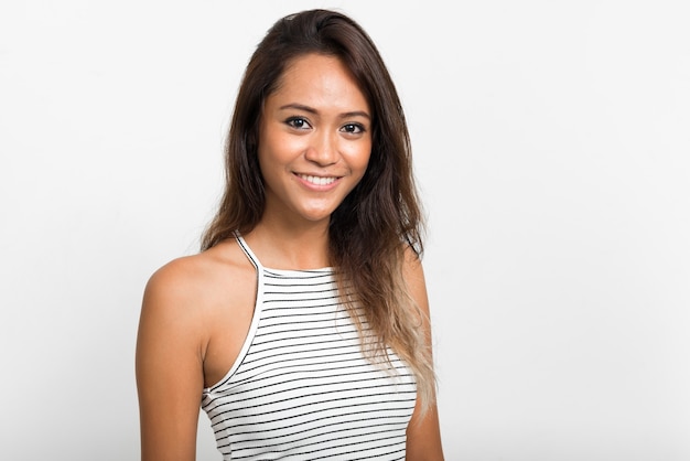 Happy young beautiful Asian woman with brown hair