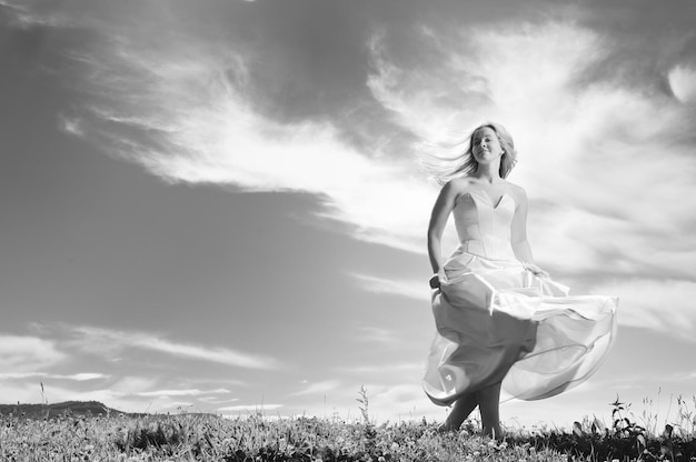 happy young beautiful bride after wedding ceremony event have fun outdoor on meadow at sunset