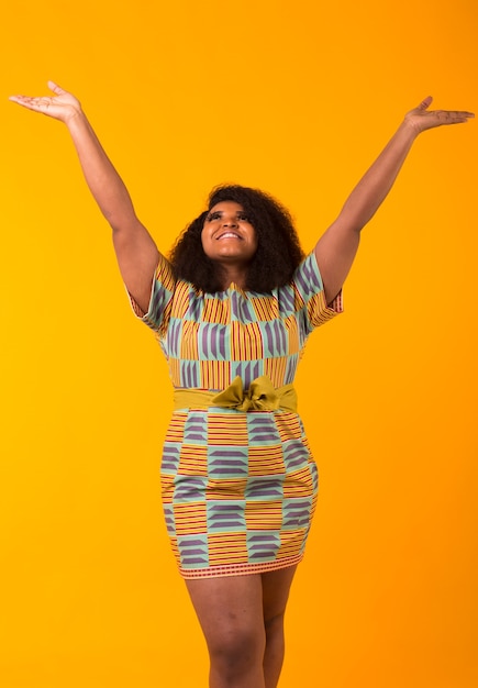 Happy young beautiful girl with an afro hairstyle.