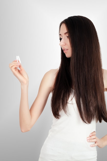 Happy young beautiful woman holding a broken cigarette