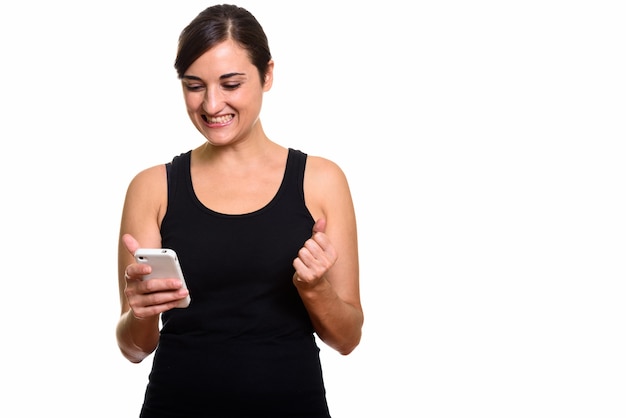 Happy young beautiful woman using phone and getting good news