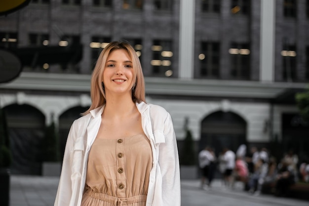 Happy young beautiful woman walking on the street Image of beautiful stylish woman