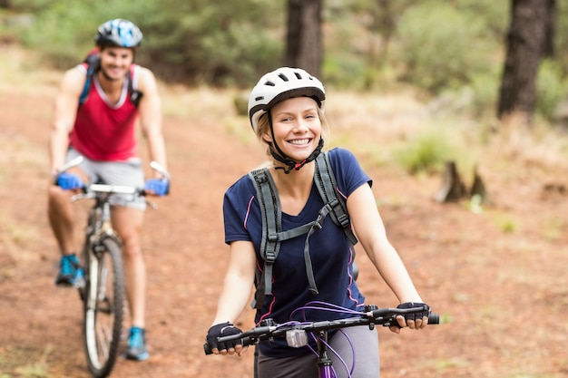 Happy young biker couple looking at camera