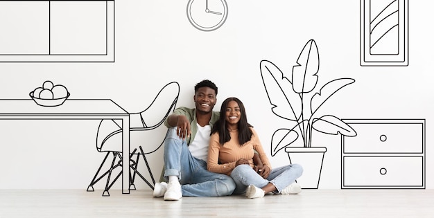 Happy young black couple hugs enjoy dreams of own house buy new home in living room interior with