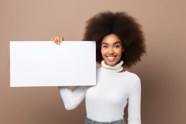 Happy young black woman holding blank white banner sign isolated studio portrait