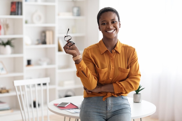 Happy young black woman posing at home