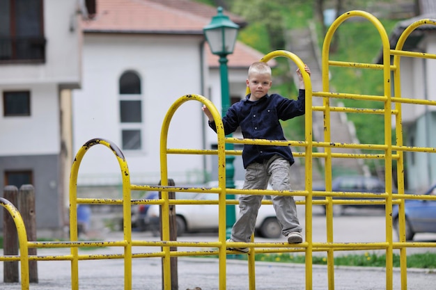 happy young blonde child boy have fun and play games outdoor in park