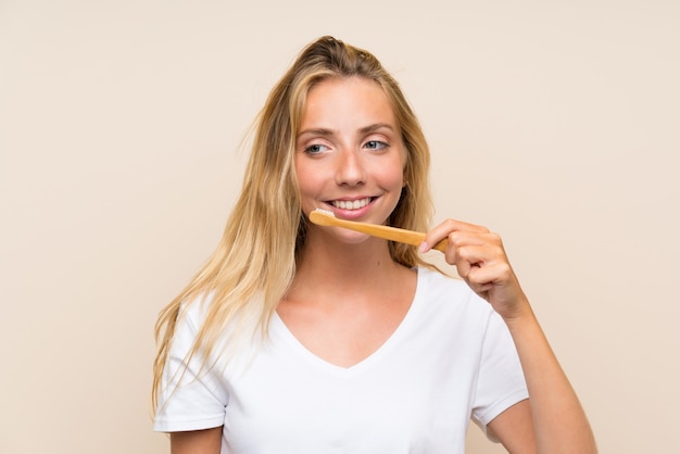 Happy Young blonde woman brushing teeths