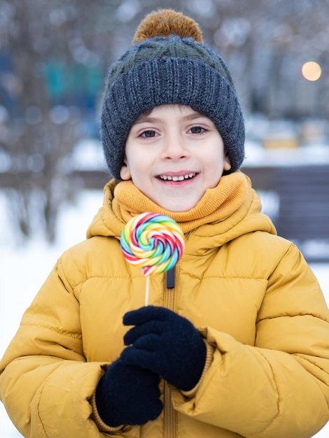 happy young boy with lollipop in winter