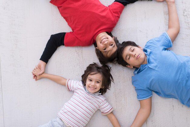 happy young boys having fun on the floor in a new modern home