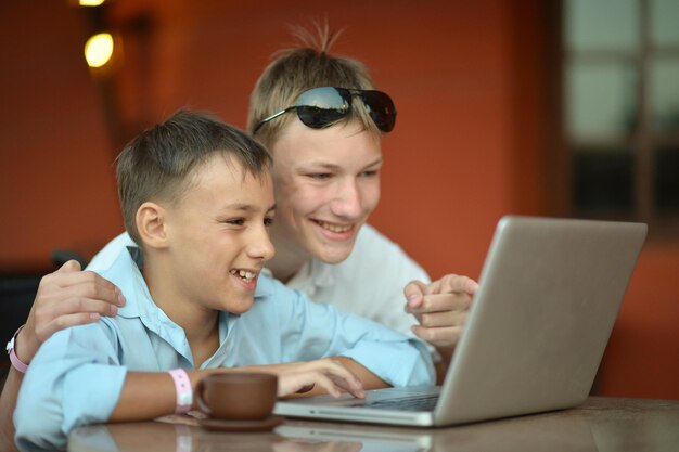 Happy Young boys using laptop computer