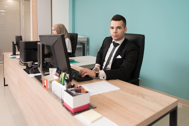 Happy Young Business Man And Muslim Woman Work In Modern Office On Computer