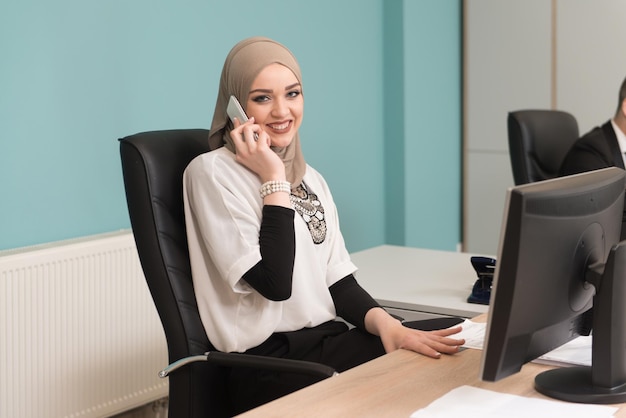 Happy Young Business Man And Muslim Woman Work In Modern Office On Computer