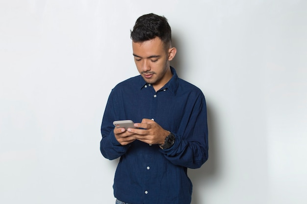 happy young business man using mobile phone isolated on white background