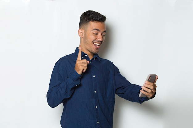 happy young business man using mobile phone isolated on white background