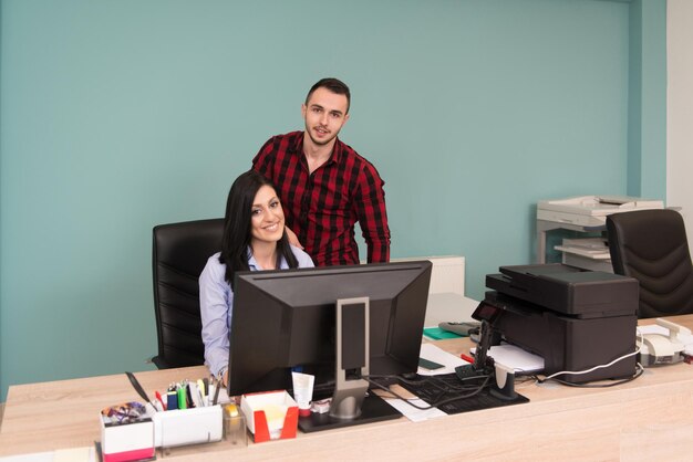 Happy Young Business Man And Woman Work In Modern Office On Computer