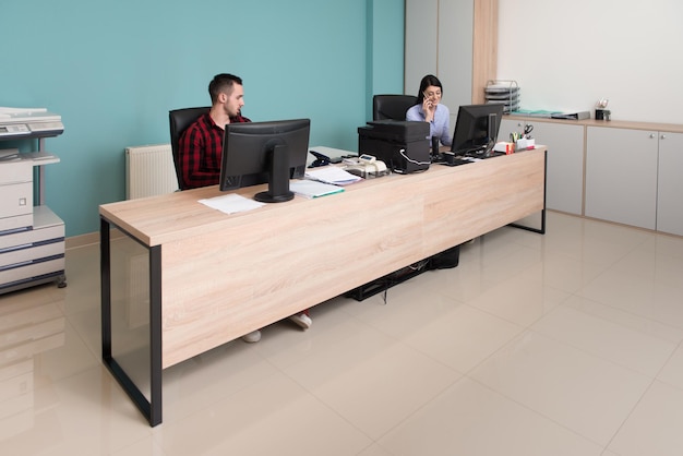 Happy Young Business Man And Woman Work In Modern Office On Computer