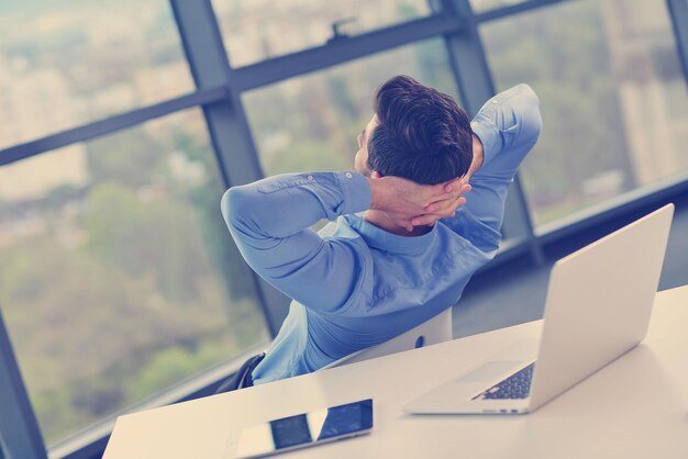 Photo happy young business  man work in modern office on computer