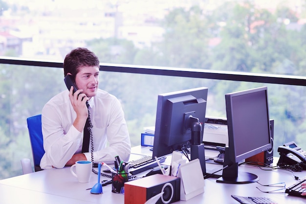 Photo happy young business  man work in modern office on computer