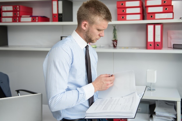 Happy Young Business Man Work In Modern Office On Papers