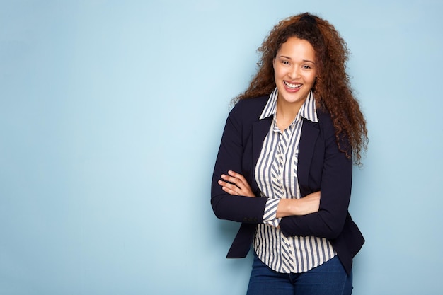 Happy young business woman smiling against blue background