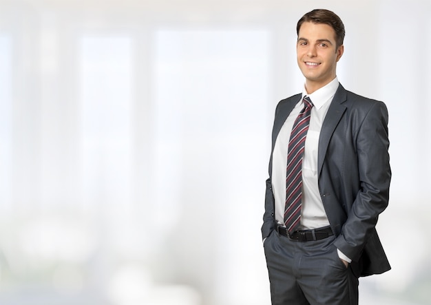 Happy young businessman on  background