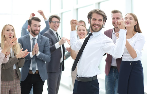 Happy young businessman on business team background