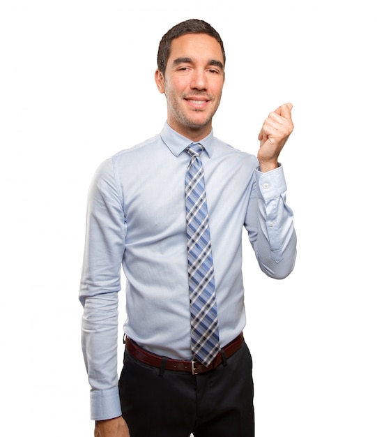 Happy young businessman doing a money gesture
