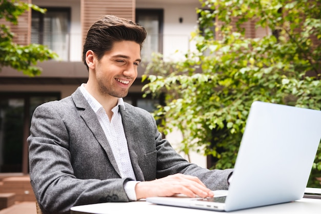 Happy young businessman dressed in suit