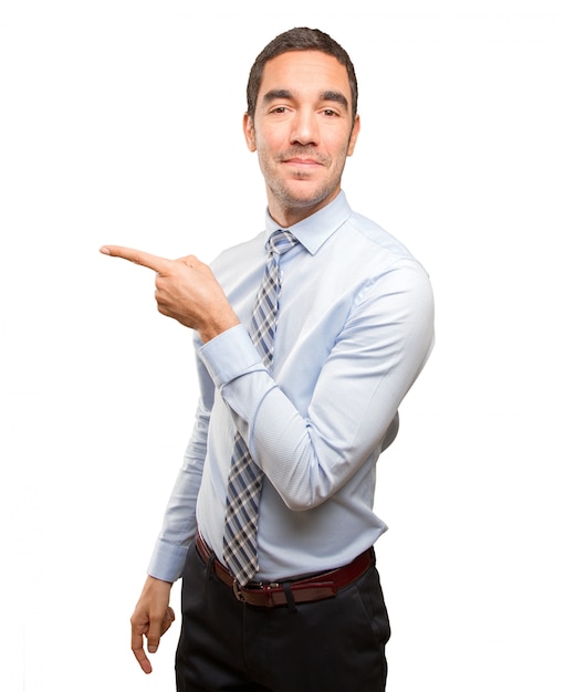 Happy young businessman pointing