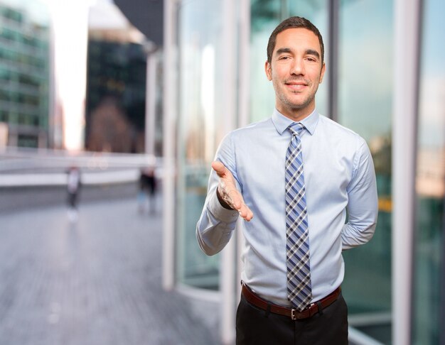 Happy young businessman welcoming