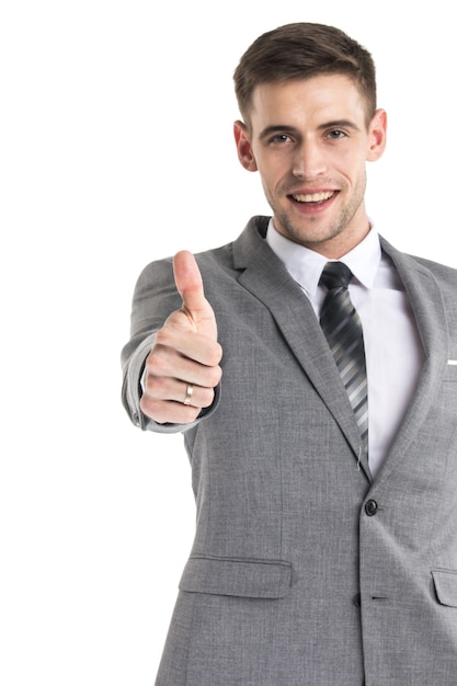 Happy young businessman with thumbs up sign isolated on white surface