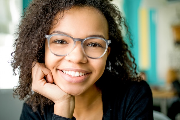 Happy young businesswoman or student in glasses