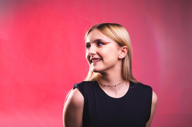 Photo happy young caucasian woman in a photography studio with a red background.