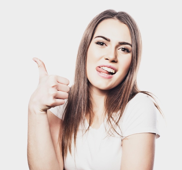 Happy young cheerful woman showing thumbs up isolated on white background