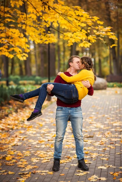 Happy young couple in the autumn park