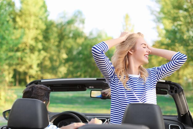 Happy young couple in car