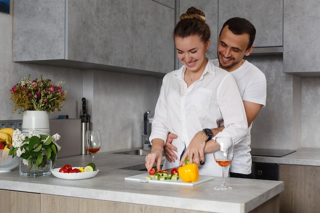 Happy young couple cooking together