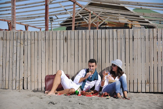 happy young couple enjoying  picnic on the beach and have good time on summer vacations